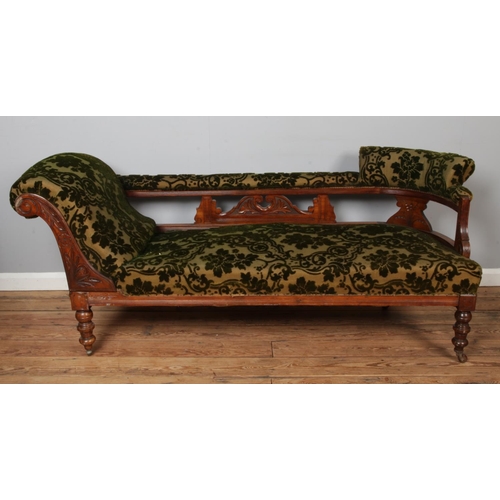 463 - A Victorian carved mahogany chaise lounge along with two matching salon chairs.