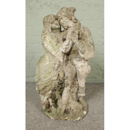 287 - A cast concrete garden statue, formed as two lovers. Height 71cm.