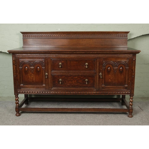 443 - A substantial oak carved sideboard/server with barley twist supports, half turned mounts and brass d... 