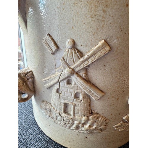 74 - A large 19th century stoneware tyg. With moulded dog handles and relief hunting/farming scenes. Heig... 