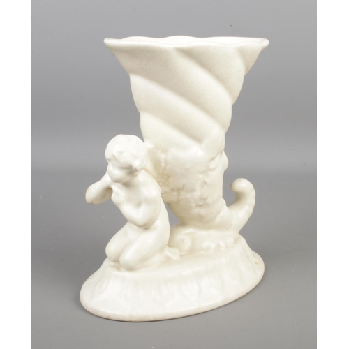 107 - A Sylvac Heirlooms pottery vase modelled as a cherub kneeled next to a cornucopia. Height 22cm.