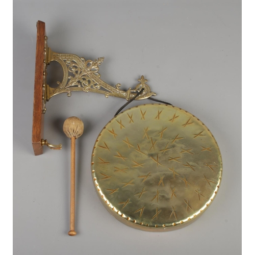 339 - An ornate wall mounted brass gong. Wall bracket marked for Townsend and Co.