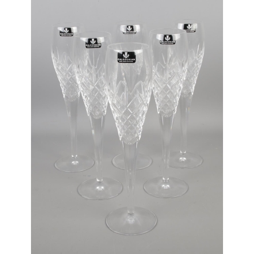 125 - A collection of six Caledonian cut crystal champagne flutes.