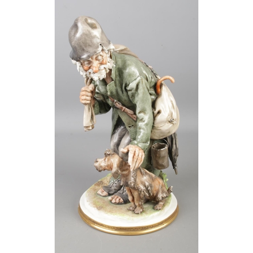 143 - A Capodimonte figure by Gelle, titled Tramp and Scamp. Height 27cm.