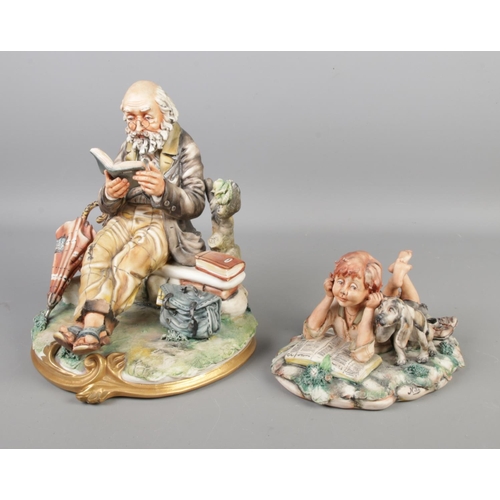 144 - Two Capodimonte figures, both by Milio. One of a man seated on a bench reading a book, the other of ... 