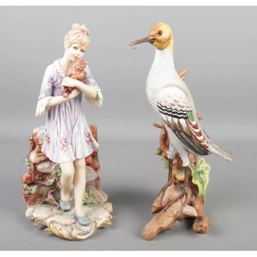 146 - Two Capodimonte figures. One modelled as a girl with a cat by Sandro, the other a bird. Both approxi... 