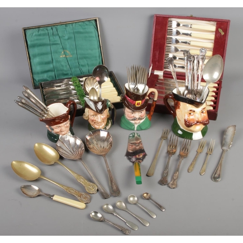 201 - A box of flatware & Toby cups collection, including two Royal Doulton 