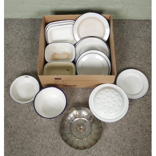 203 - A collection of vintage kitchenalia, mainly blue and white enamel examples. Includes plates, pans an... 