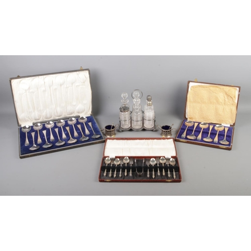 31 - Three cased sets of flatware, together with a six piece cruet set and two sauce pots with blue glass... 