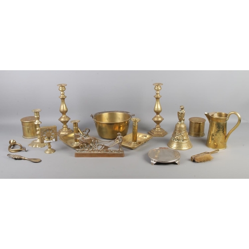 33 - A collection of brassware's including candlesticks, chamber sticks, jug, jam pan, trench art tobacco... 