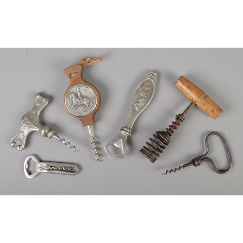 37 - A collection of corkscrews and bottle openers; to include early German spring and Danish pewter hand... 