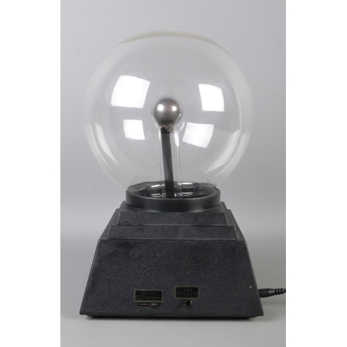 38 - A spherical plasma ball, on stepped square base. Height: 32cm.