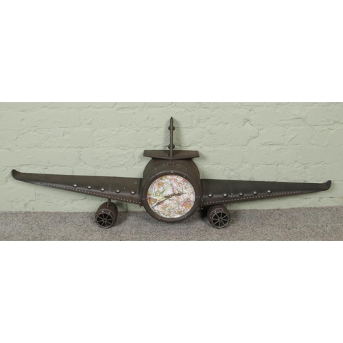 260 - A retro metal aeroplane clock, with altered map dial. Width of wings: 141cm.