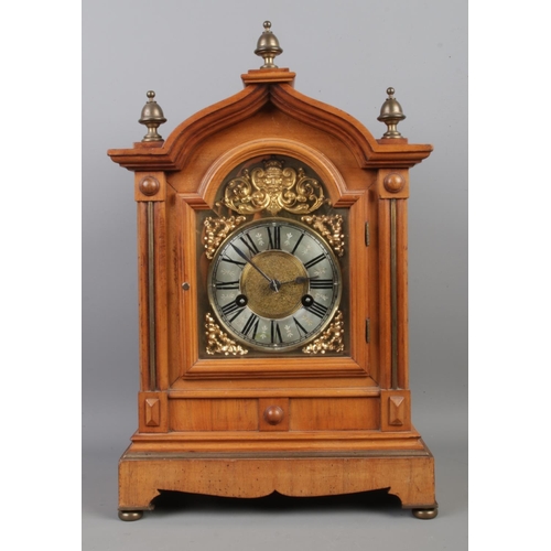 2 - A substantial walnut mantle clock, with ornate brass dial featuring Roman Numeral markers and brass ... 