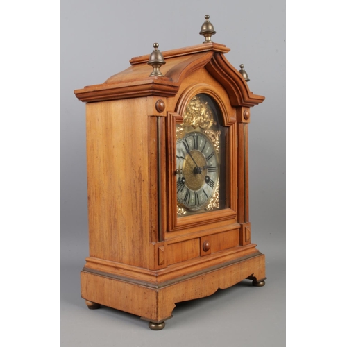 2 - A substantial walnut mantle clock, with ornate brass dial featuring Roman Numeral markers and brass ... 