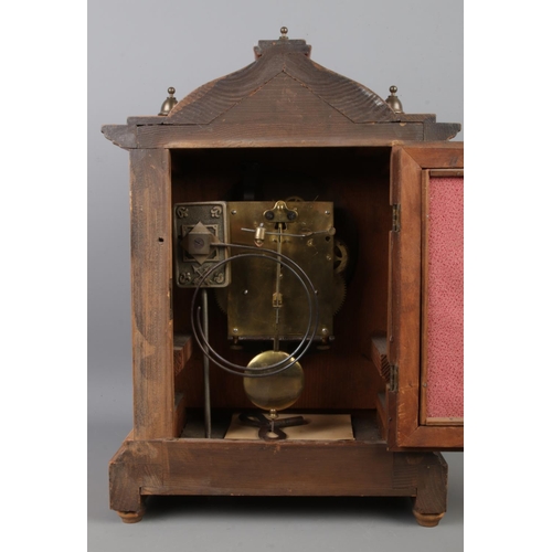 2 - A substantial walnut mantle clock, with ornate brass dial featuring Roman Numeral markers and brass ... 