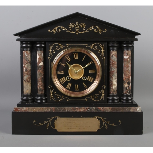 48 - A slate and marble mantle clock, featuring Corinthian style columns and bearing presentation plaque ... 