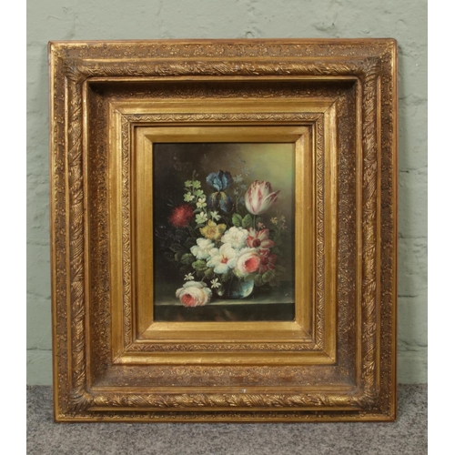 319 - A still life print depicting a bouquet of flowers within a vase, mounted in a decorative gilt frame.... 