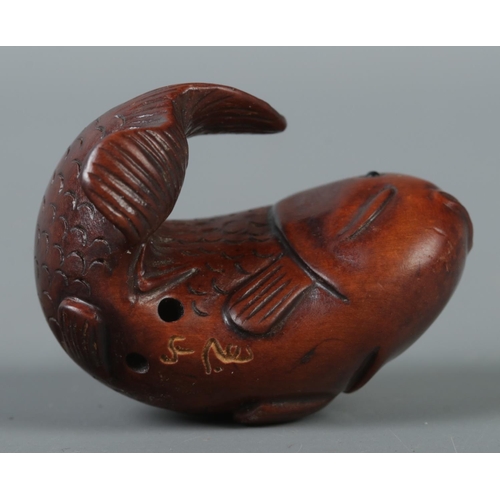 346 - A hand carved hardwood netsuke formed as koi fish, signed to base.