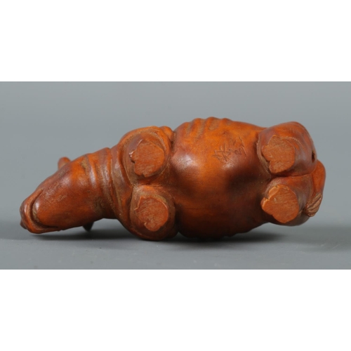 347 - A hand carved hardwood netsuke formed as a rhinoceros, signed to base.