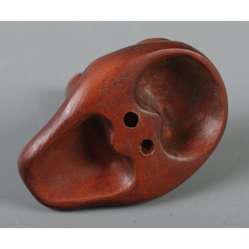 349 - A hand carved hardwood netsuke formed as a Tengu mask, signed to reverse.