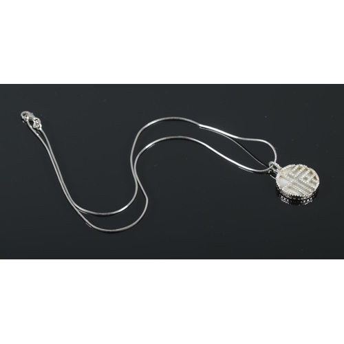 380 - A 18ct White Gold and mother of pearl pendant, set with with small diamonds. Suspended on 18ct White... 