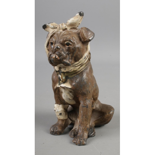 385 - An early Twentieth Century Bergman style cold painted base metal figure of a dog, wrapped in bandage... 