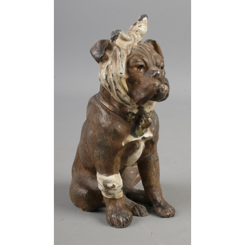 385 - An early Twentieth Century Bergman style cold painted base metal figure of a dog, wrapped in bandage... 