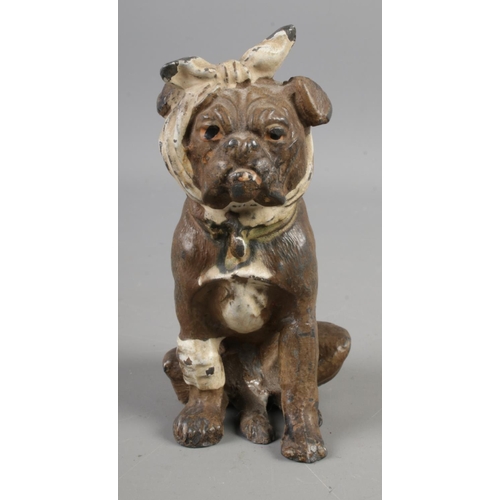 385 - An early Twentieth Century Bergman style cold painted base metal figure of a dog, wrapped in bandage... 