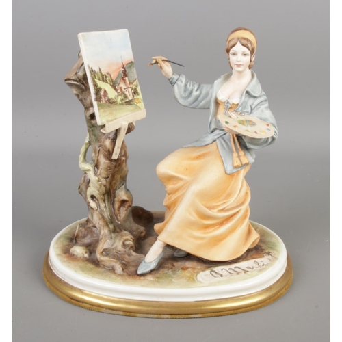 389 - A Capodimonte porcelain figurine 'Lady Artist', sculptured by Bruno Merll. Measures height 21cm, wid... 