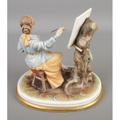 389 - A Capodimonte porcelain figurine 'Lady Artist', sculptured by Bruno Merll. Measures height 21cm, wid... 