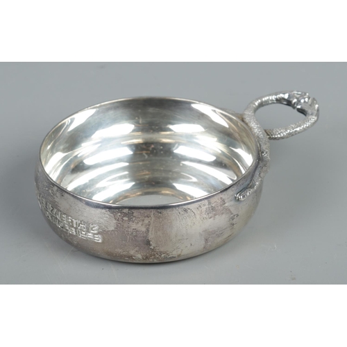 395 - A Twentieth Century silver tastevin, with the handle formed from two serpents. Bearing commemorative... 