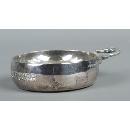 395 - A Twentieth Century silver tastevin, with the handle formed from two serpents. Bearing commemorative... 