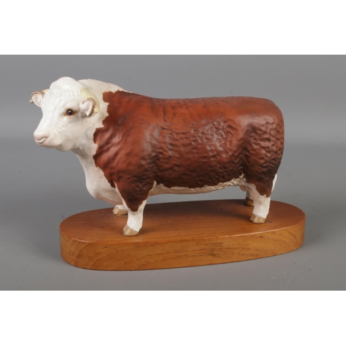 402 - A Beswick figure on wooden stand, Hereford Bull.