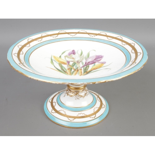 79 - A Minton hand painted botanical comport featuring central crocus motif surrounded with gilt Greek ke... 