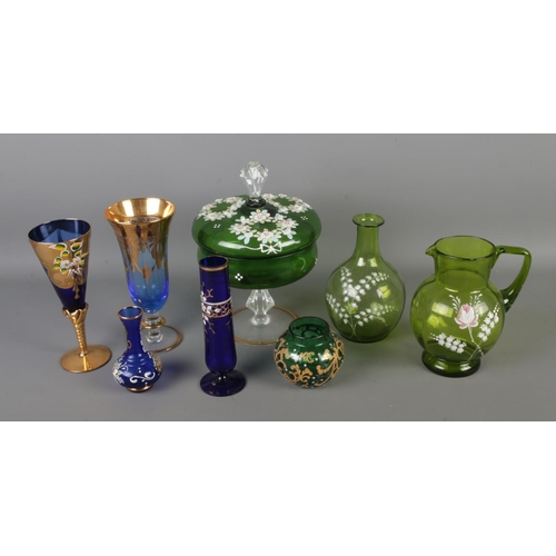 83 - A collection of coloured glassware to include pair of painted green glass jug, blue drinking glasses... 