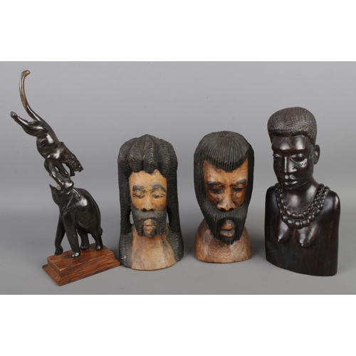 84 - A vintage artisan collection of solid wood hand-carved pieces, featuring three statue busts and an I... 