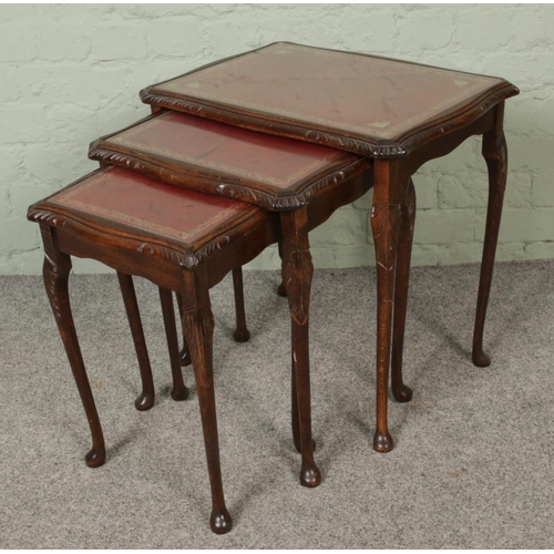 408 - A mahogany nest of tables with leather inset top