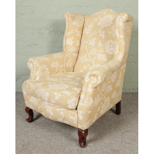 413 - A 20th century upholstered armchair