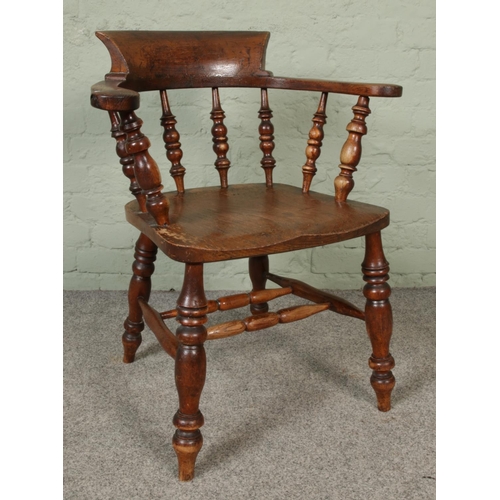 415 - A 19th century smokers bow arm chair.