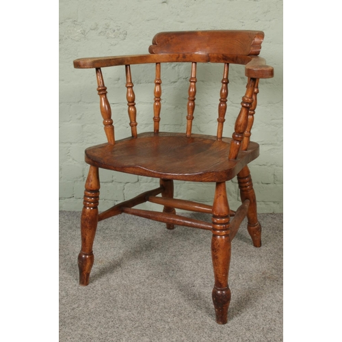 416 - A 19th century smokers bow arm chair.