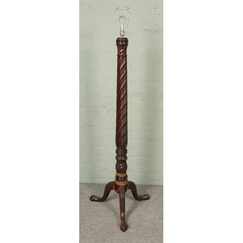 417 - A carved mahogany standard lamp with ball and claw feet and twist carved column