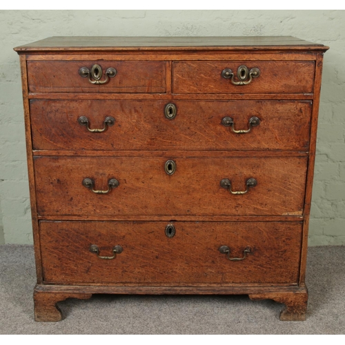 419 - A Georgian oak chest of drawers with swan neck handles and brass escutcheons.