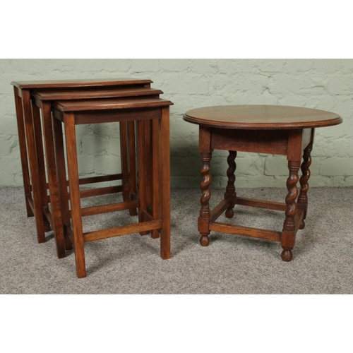 422 - A nest of three mahogany tables, together with a circular topped oak occasional table, with barley t... 