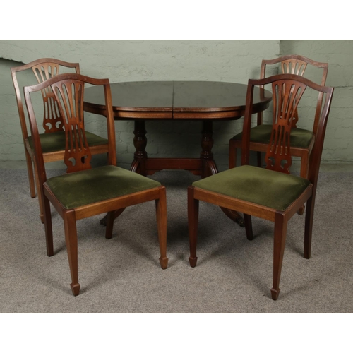 426 - A vintage mahogany extendable dining table with brass lion feet, accompanied by four chairs. Dimensi... 