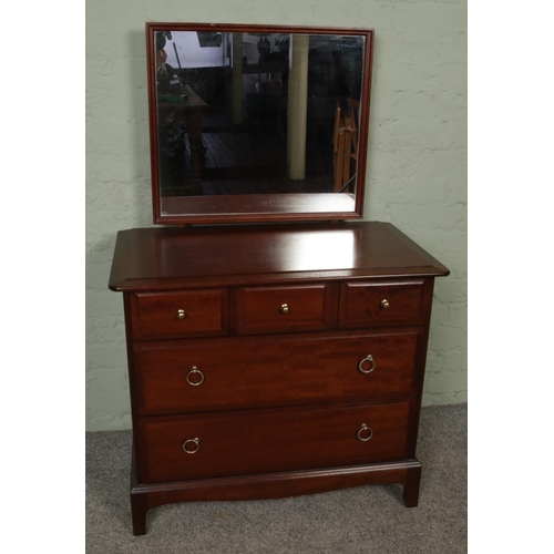 435 - A Stag Minstrel chest of drawers with dressing mirror Height 127cm, Width 82cm, Depth 47cm.