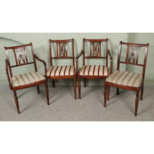 439 - A set of four vintage dining chairs, featuring sabre legs and drop-in multi-colour cushioned seat pa... 