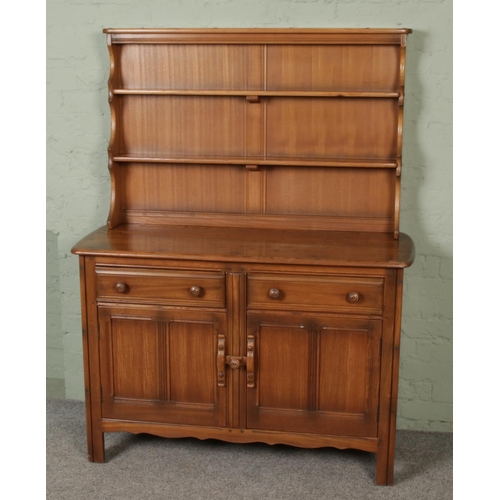 446 - A vintage Ercol elm two part sideboard dresser with shelf, the base has two drawers and two twin-pan... 