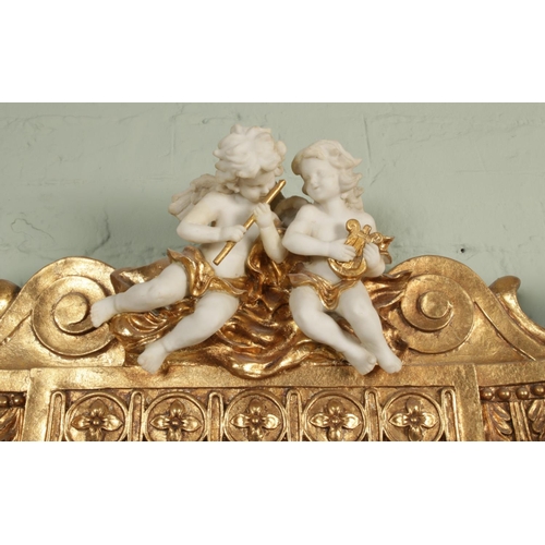 454 - A Rococo style gilt wood console table and matching mirror, with white marble top and figural decora... 