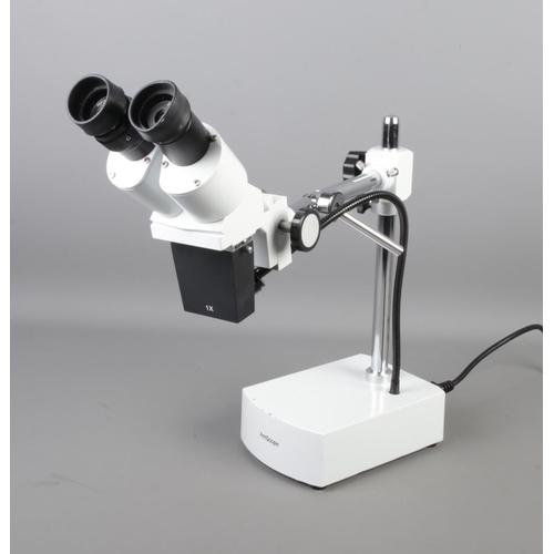 96 - An Amscope binocular 10X-20X stereo microscope on boom-arm with light. Comes with original box and a... 